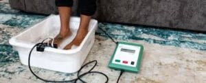 Client receiving an ionic foot detox session with IonCleanse machine in Aiken SC